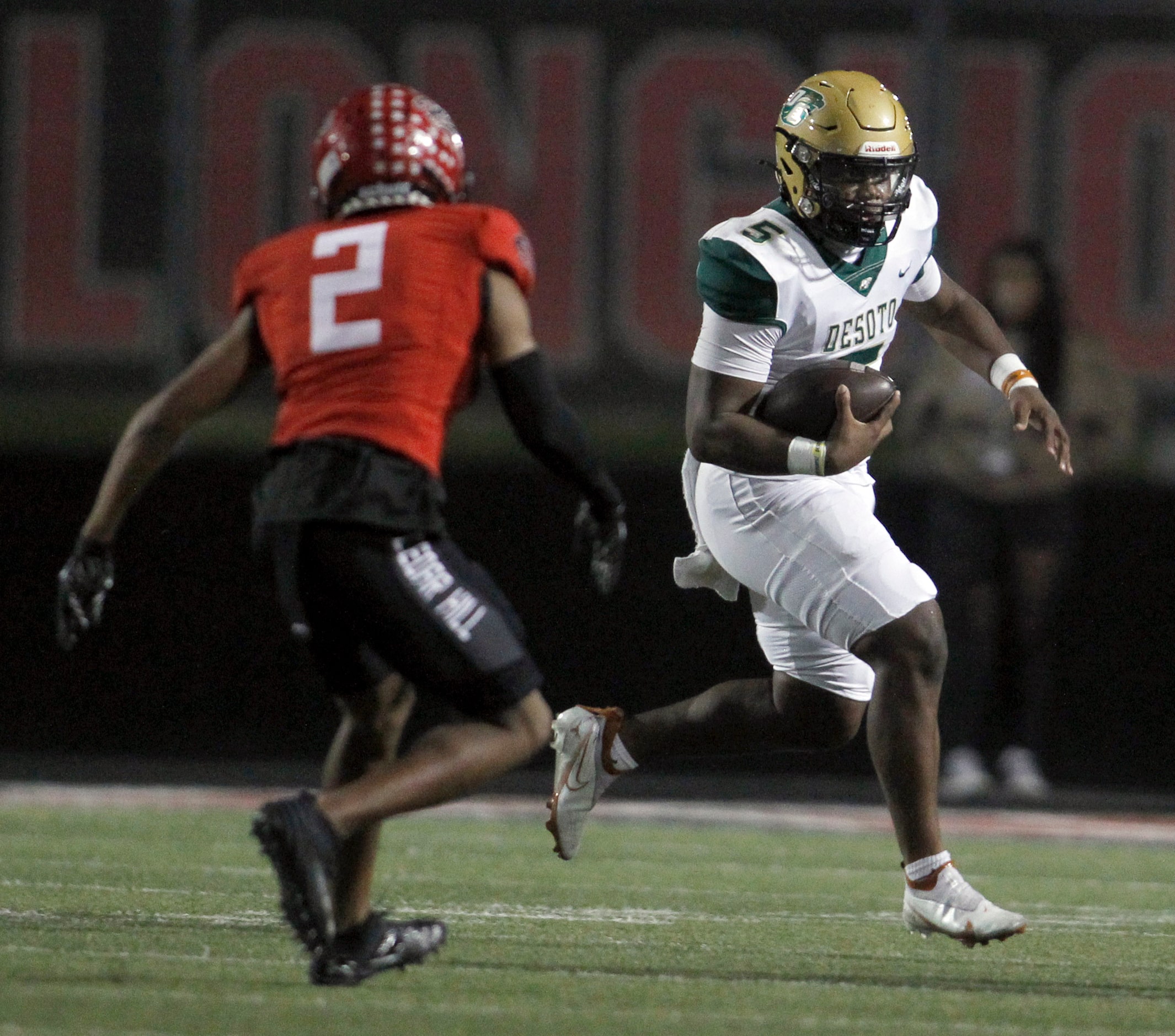 DeSoto quarterback Darius Bailey (5) rushes for positive yards as Cedar Hill free safety...