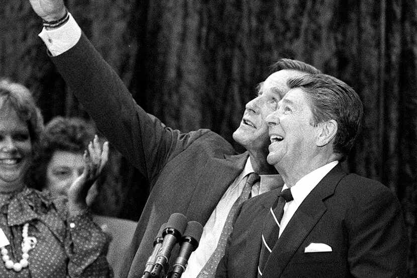 President Ronald Reagan and Vice President George H.W. Bush react to cheering supporters and...