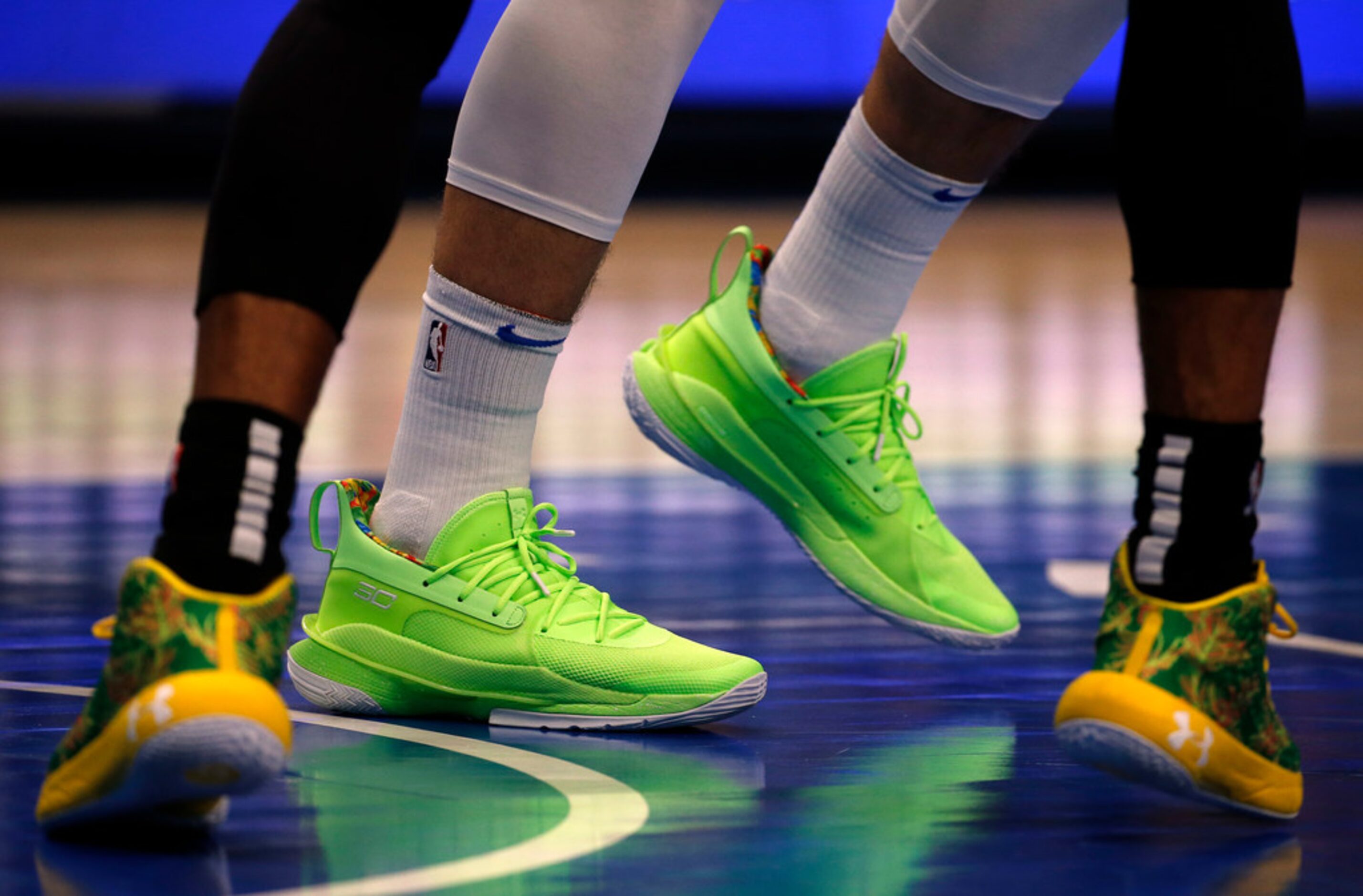 Dallas Mavericks forward Luka Doncic (center) wore “Sour Patch Kids” UA Curry 7 shoes as San...