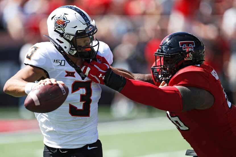 Oklahoma State's Spencer Sanders (3) is tackled by Texas Tech's Broderick Washington Jr....