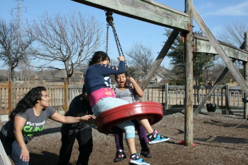 Dulce Gabriel, front, plays on the tire swing with friends at the Mary Heads Carter Park...