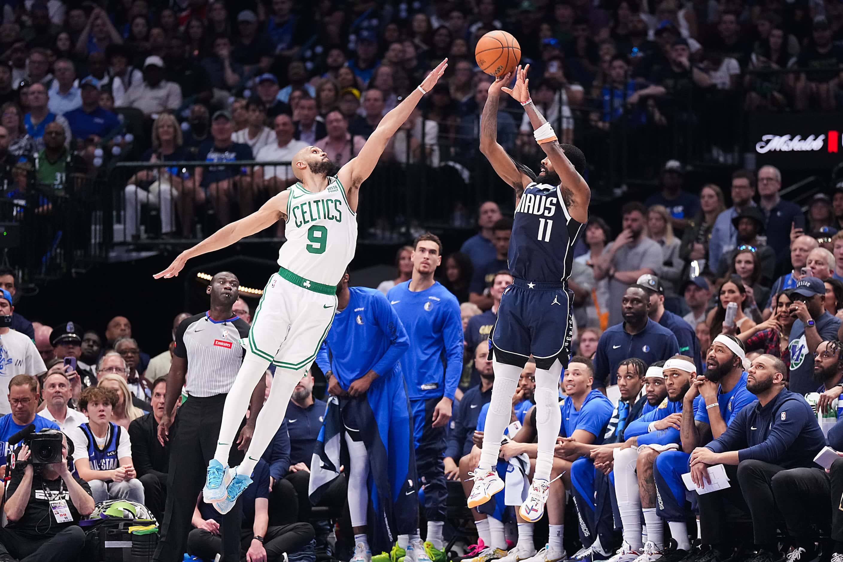 Dallas Mavericks guard Kyrie Irving (11) shoots over Boston Celtics guard Derrick White (9)...