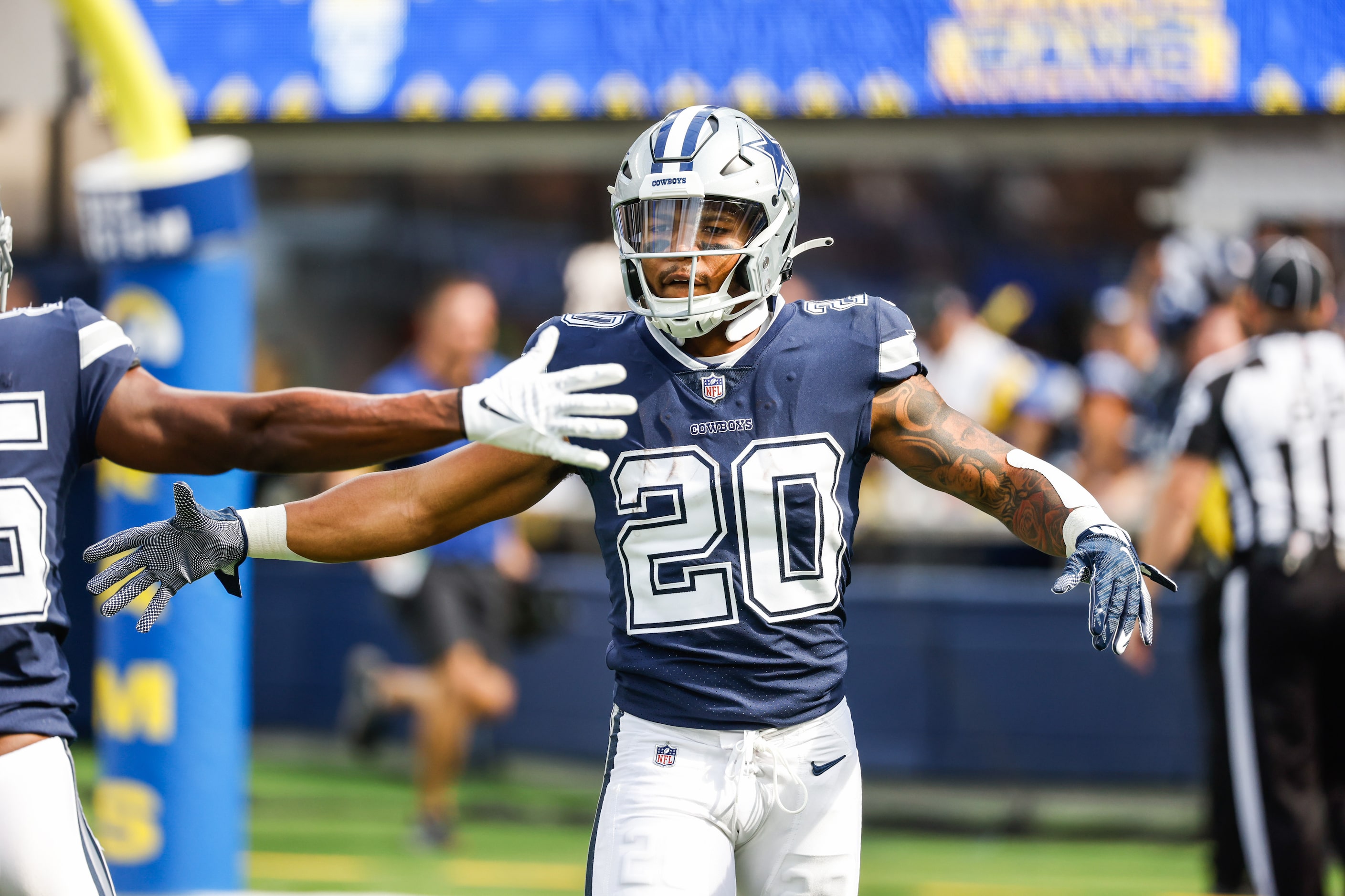 Dallas Cowboys running back Tony Pollard (20) celebrates a touchdown with his teammates...