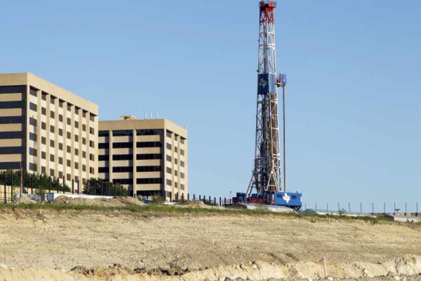 A gas drilling rig operated by Fort Worth-based Union Drilling sits near Bryant Irvin Road...