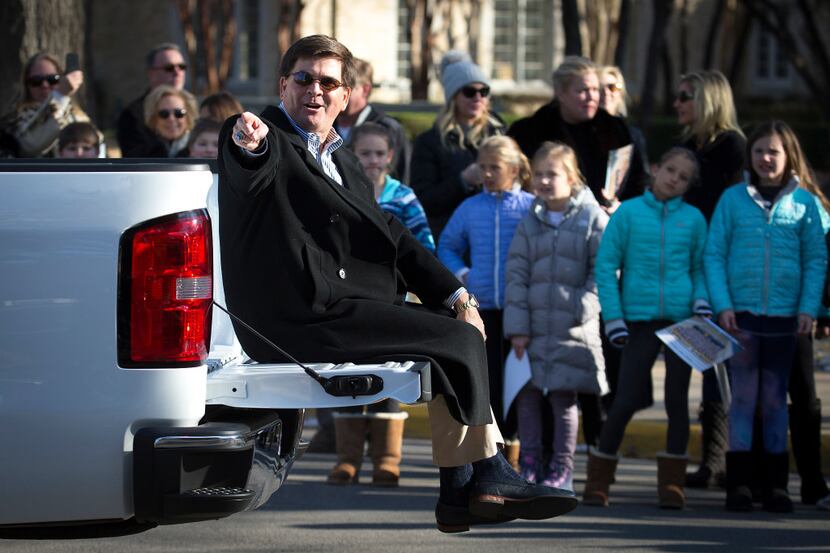 Highland Park athletic director Johnny Ringo waves from a truck as the Highland Park...