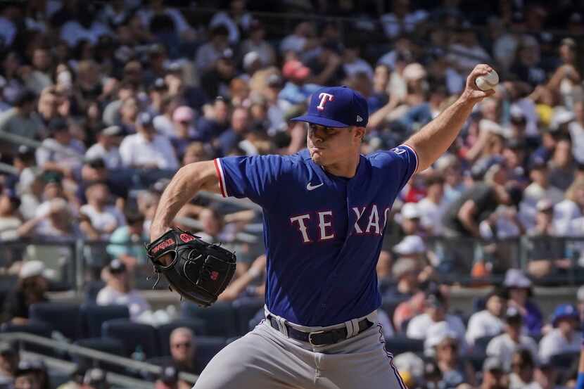 Texas Rangers relief pitcher John King pitches during the eighth inning of a baseball game...