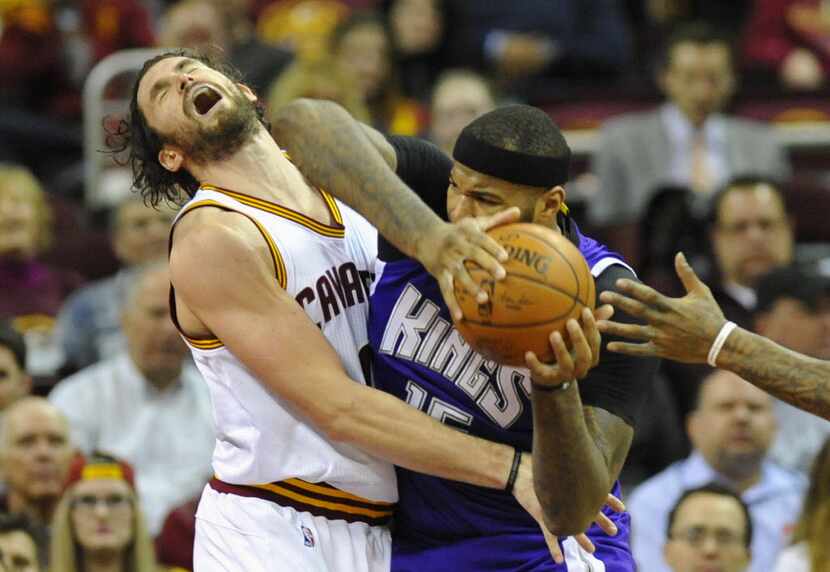 Cleveland Cavaliers forward Kevin Love (0) defends Sacramento Kings center DeMarcus Cousins...