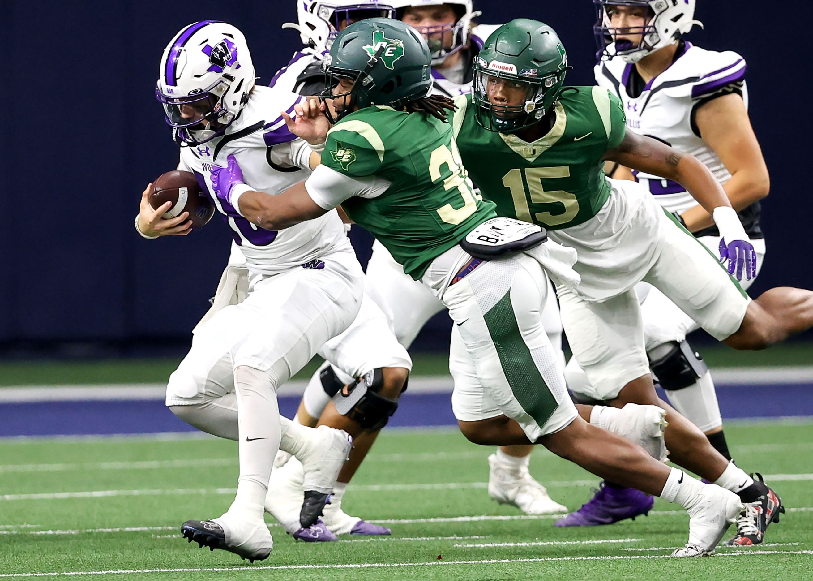 Willis quarterback Jack Emerson (Left) is dragged down by DeSoto linebacker Jackson Curry...