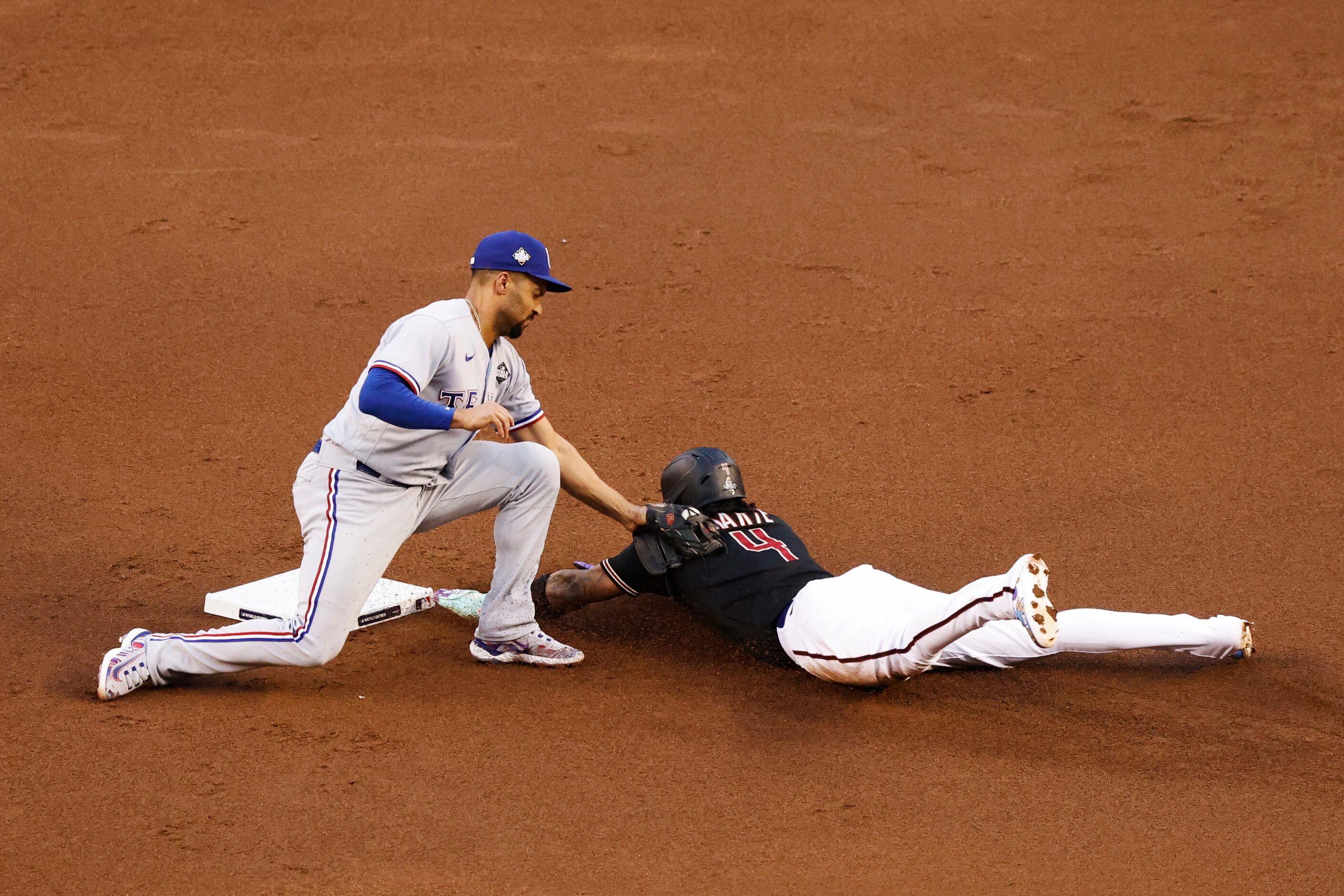 Arizona Diamondbacks’ Ketel Marte (4) is tagged out by Texas Rangers second baseman Marcus...