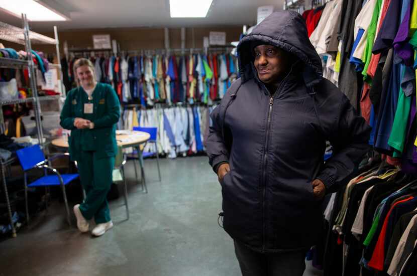 Cecelia Nash (right) tried on a new jacket at the Cornerstone Baptist Church's Clothes...