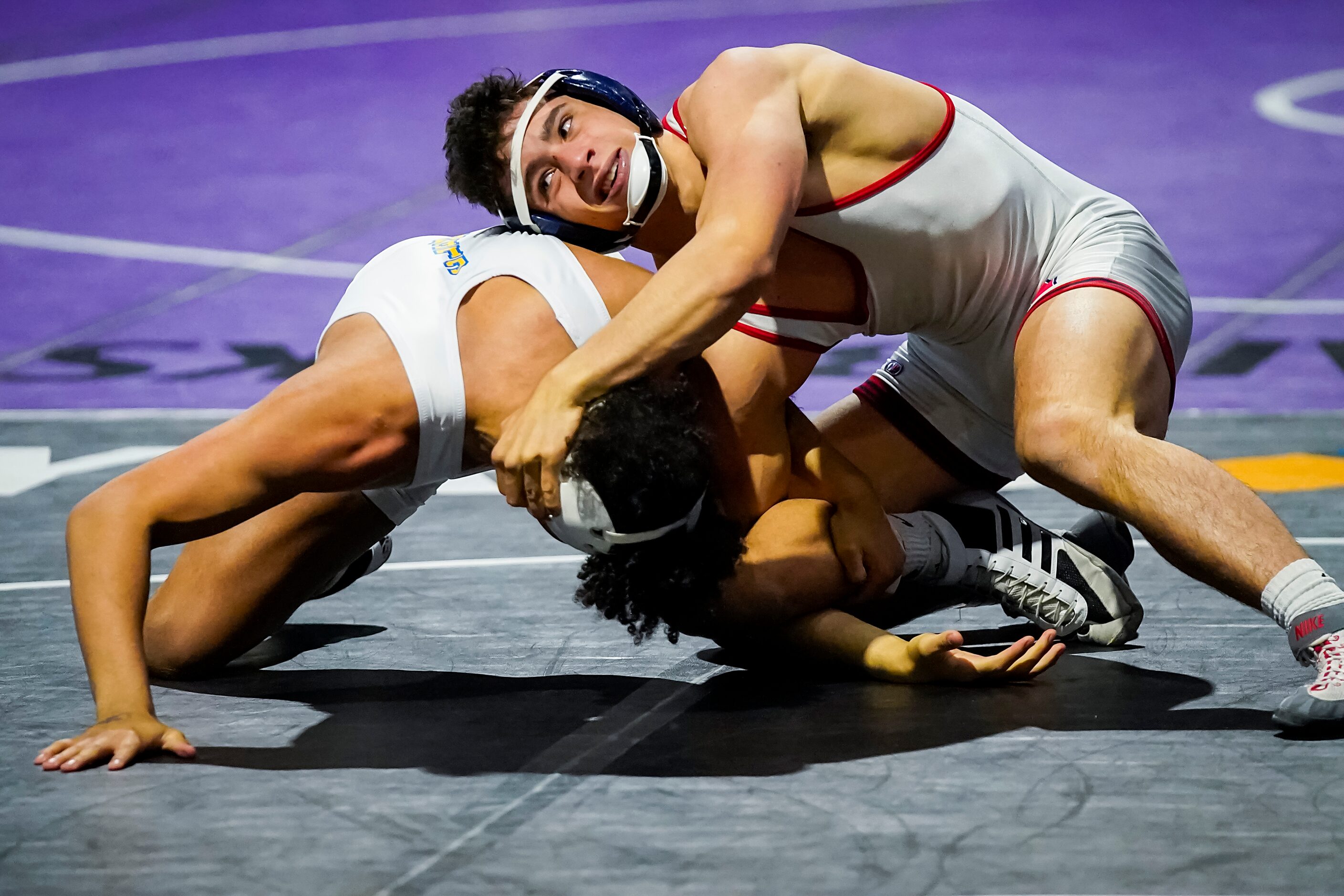 Ryan Nichols of Allen (top) wrestles Darwin Hull of Schertz Clemens for the 6A boys...