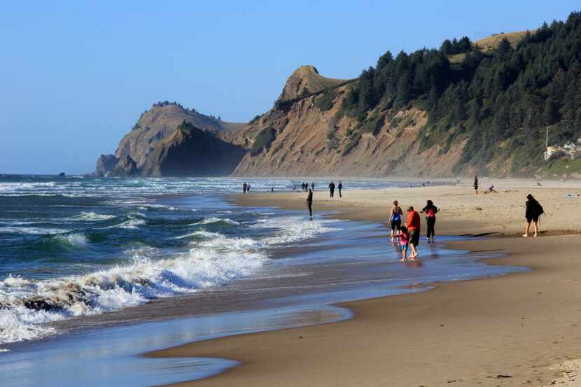 This May 2010 photo shows people on a stretch of beach in Lincoln City, Ore. As of 2014,...
