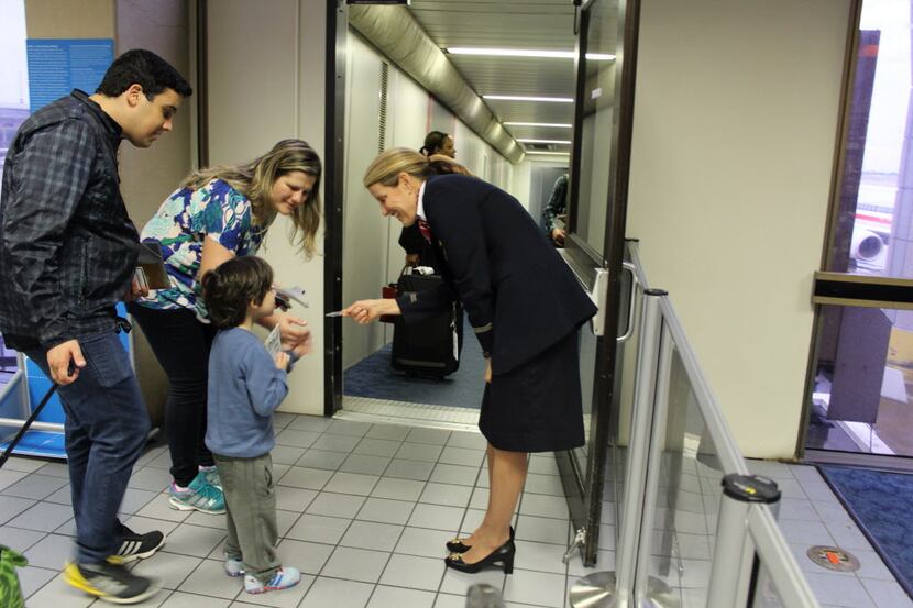 American Airlines flight attendant Laura Borgini gave a wings pin to a young child boarding...