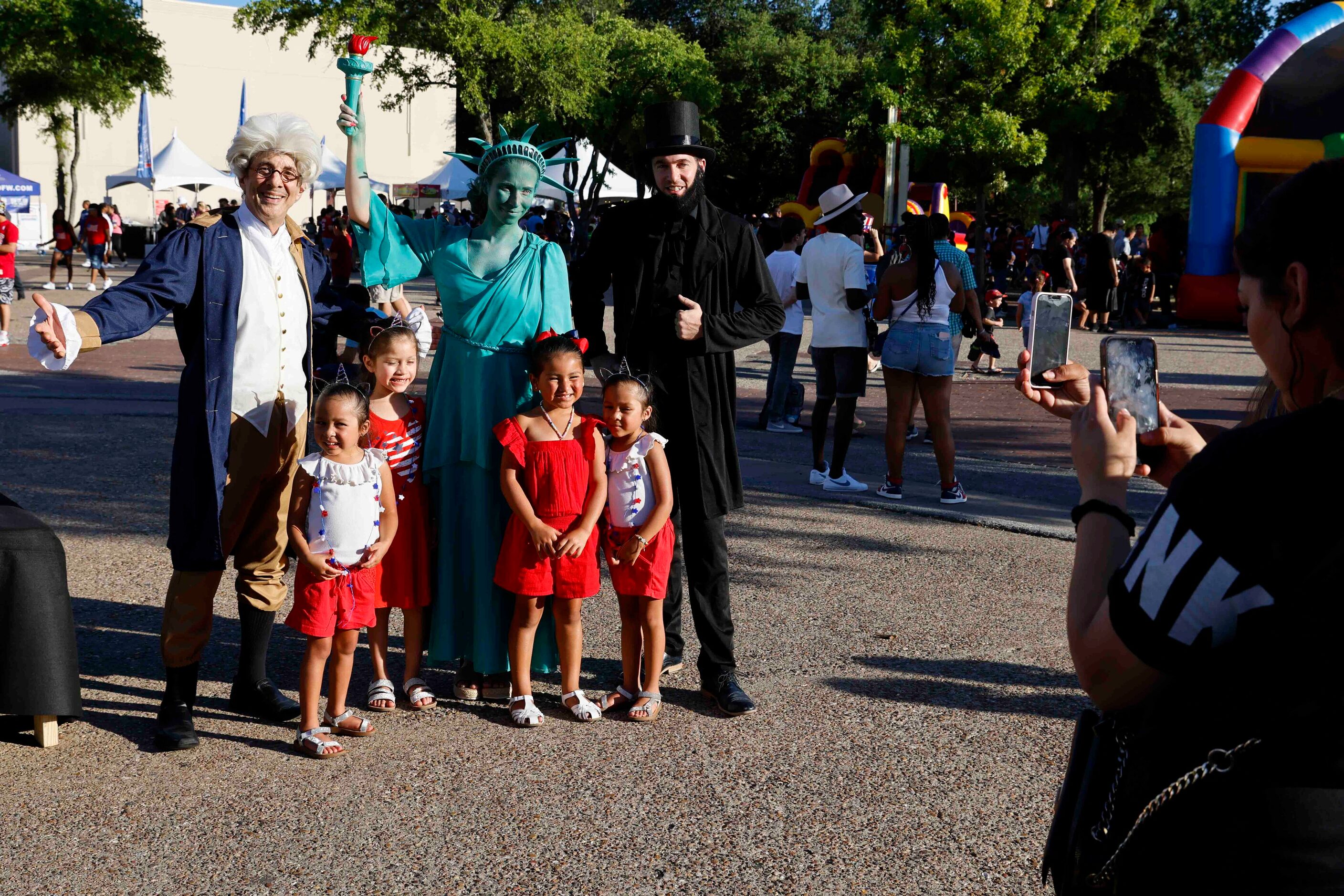 From left. Ari Jones dressed as President John Adams, Anna Gilday, dressed as Statue of...