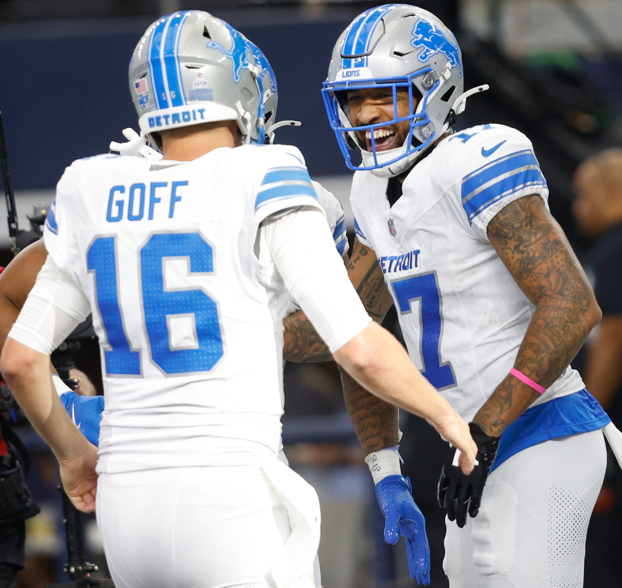 Detroit Lions wide receiver Tim Patrick (17) is congratulated by his teammate  quarterback...