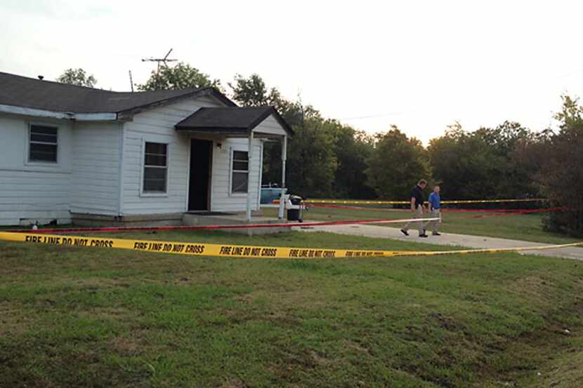 Fire line and crime scene tape surrounds the home of Charles Everett Brownlow Jr. Tuesday...