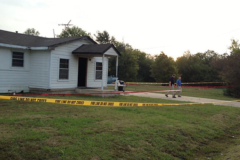 Fire line and crime scene tape surrounds the home of Charles Everett Brownlow Jr. Tuesday...