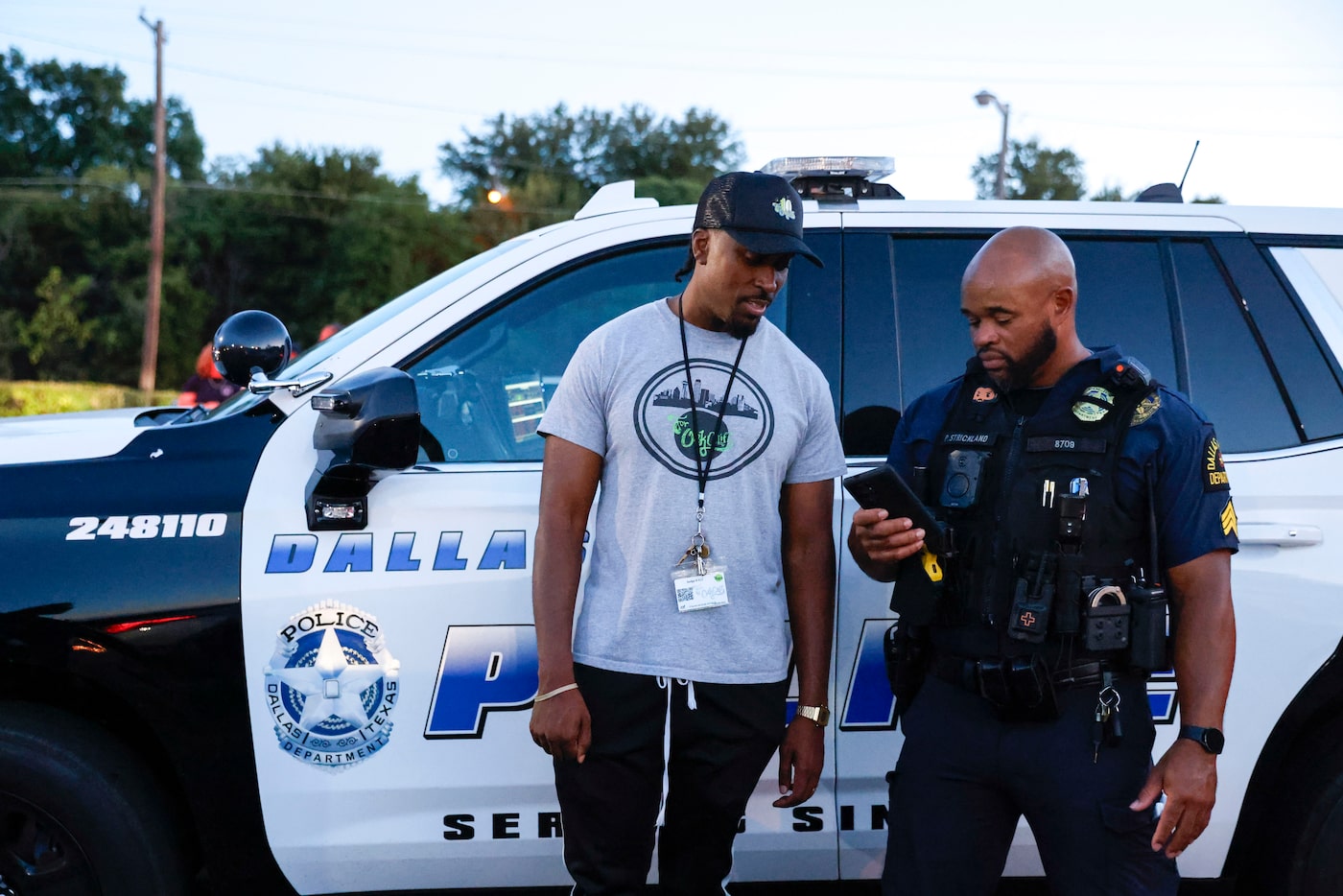 Taylor Toynes, (left), For Oak Cliff co-founder, talks to Perry Strickland with Dallas...