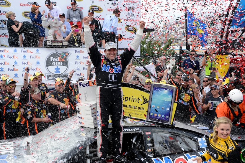 Tony Stewart celebrates in Victory Lane after he won a NASCAR Sprint Cup Series auto race,...