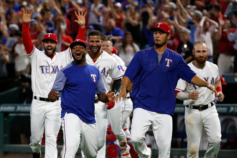 The Texas Rangers celebrate first baseman Mike Napoli's (5) 3-run home run against the San...