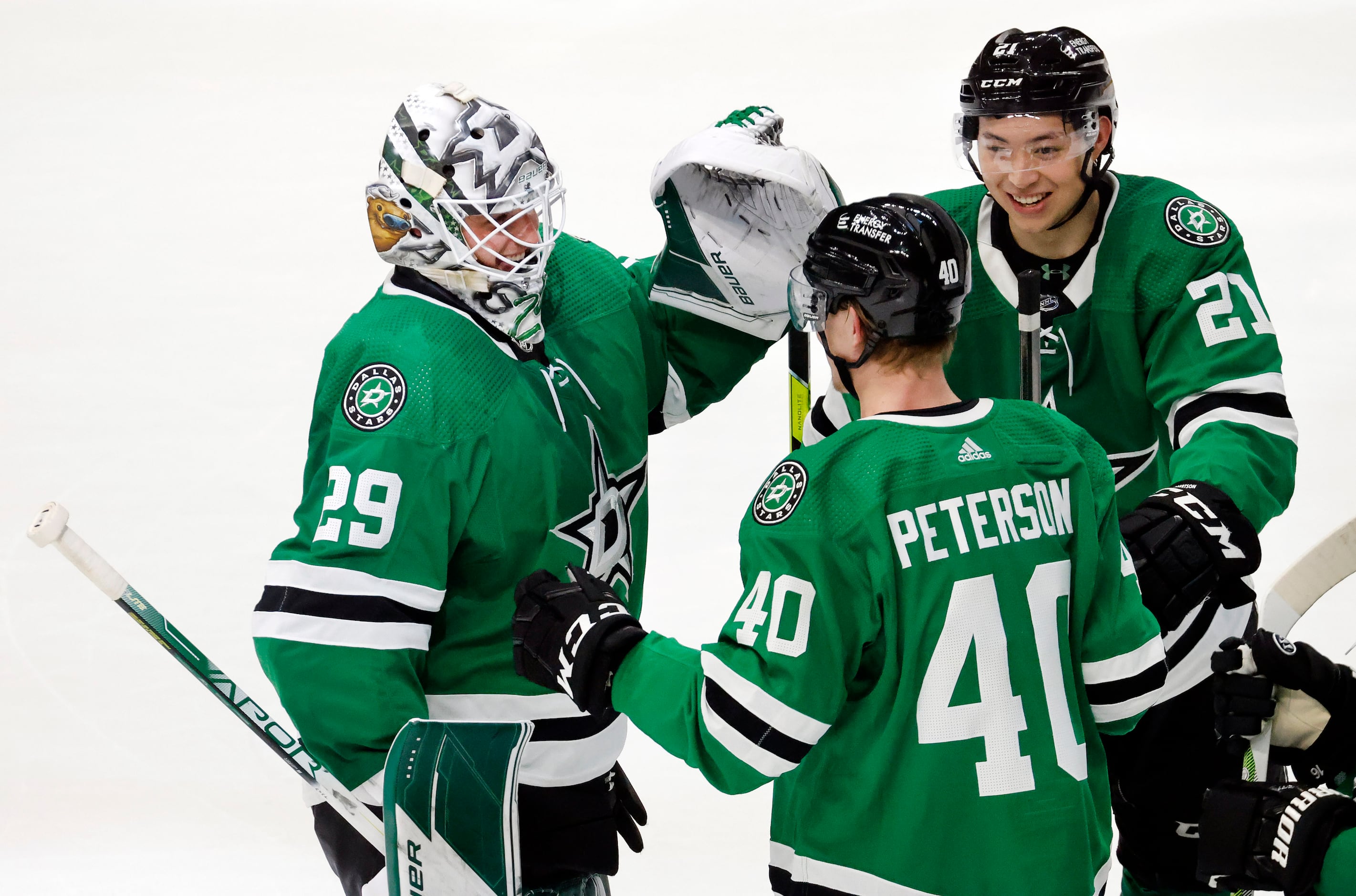 Dallas Stars goaltender Jake Oettinger (29) is congratulated by teammates Jason Robertson...