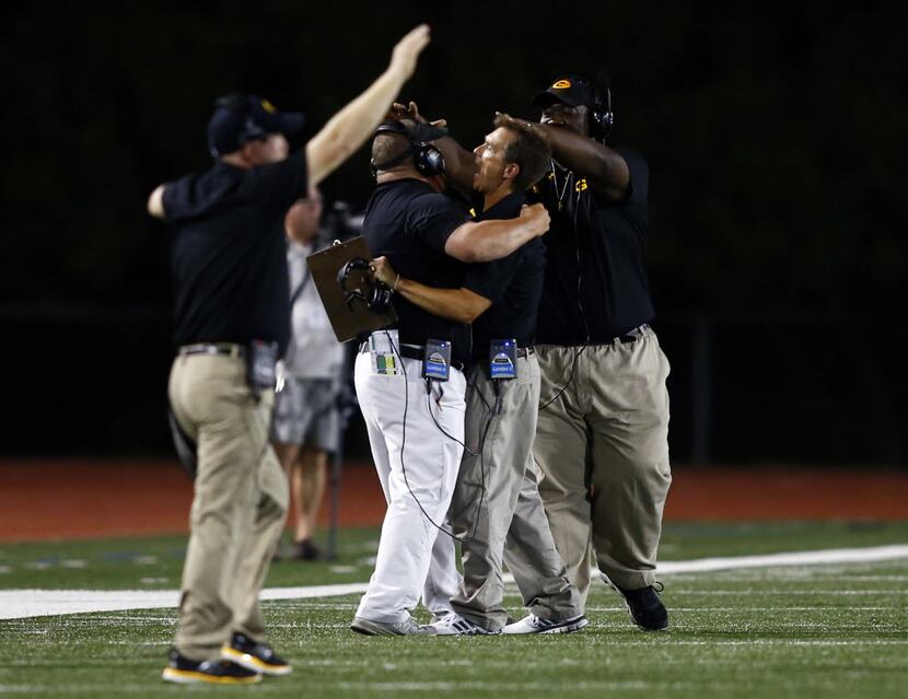 TXHSFB Garland head coach Jeff Jordan and his staff celebrate in the closing moments of the...