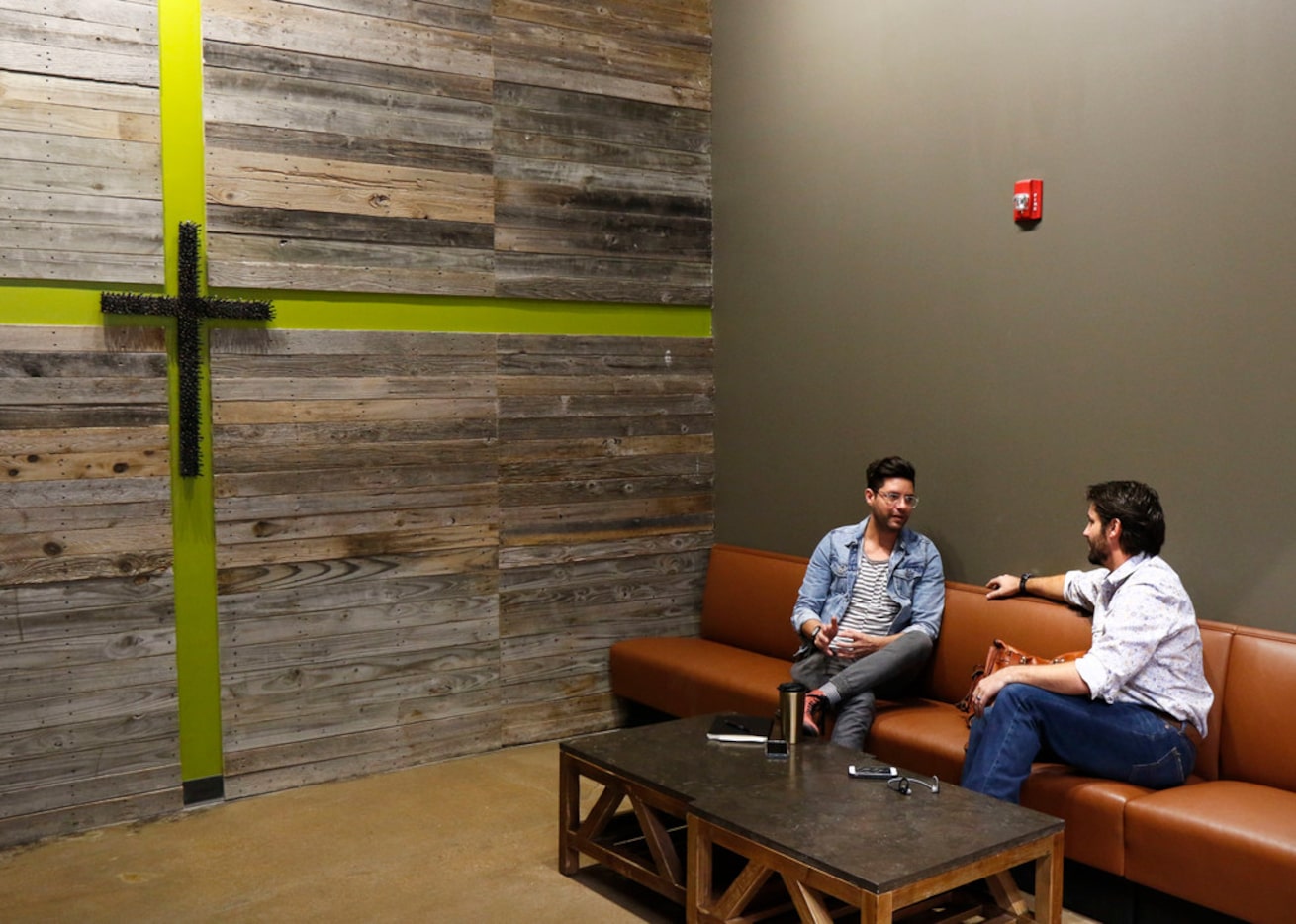 Kevin Tipps, left, and Jacob Robert relax at Hands + Rose Coffee, located inside of Upper...