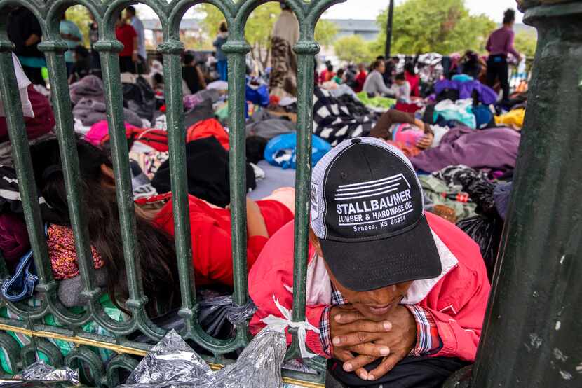 Laureano Sanchez, a migrant from Guatemala, lies among dozens of other expelled migrants...