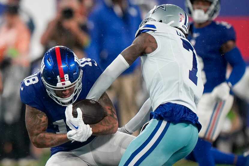 Dallas Cowboys cornerback Trevon Diggs (7) strips the ball from New York Giants wide...