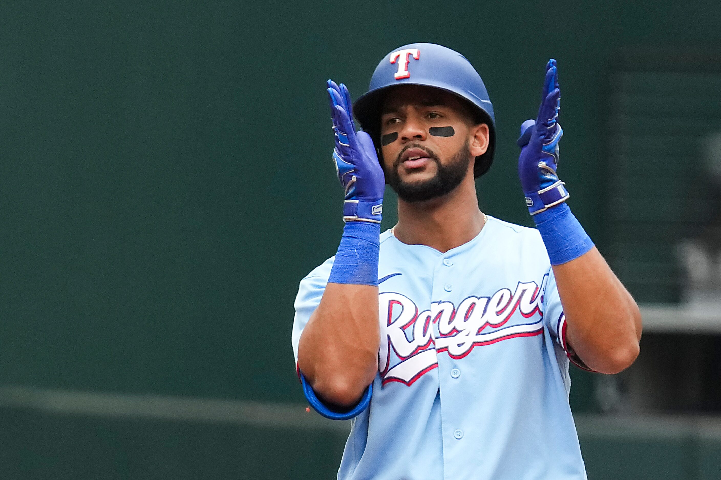 Texas Rangers center fielder Leody Taveras celebrates at second base after driving in three...