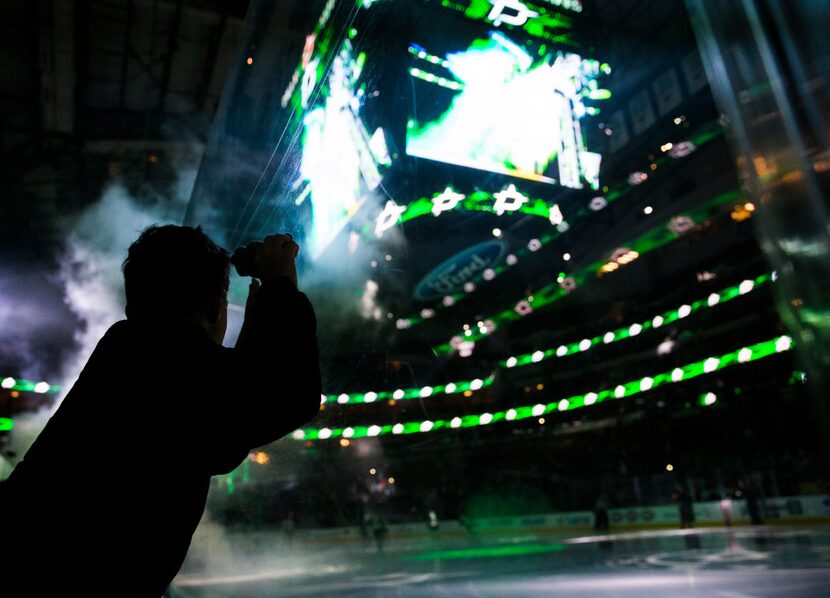 Aiden Gann, 8, watches as the Dallas Stars take the ice before their game against the...