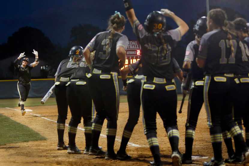 Forney sophomore 2nd baseman Trinity Cannon (7) started the celebration as she came down the...