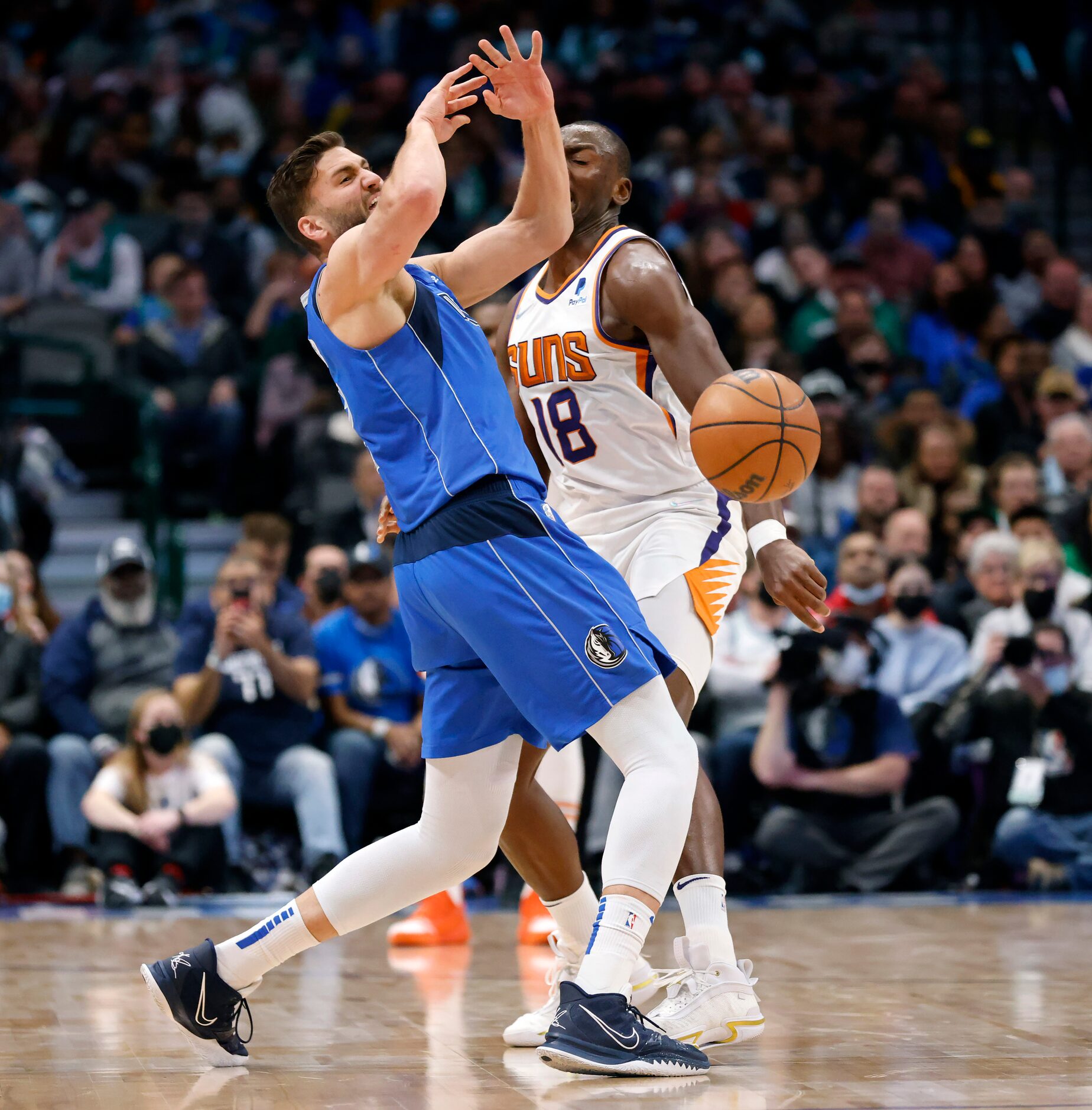 Dallas Mavericks forward Maxi Kleber (42) is fouled by Phoenix Suns Bismack Biyombo (18)...