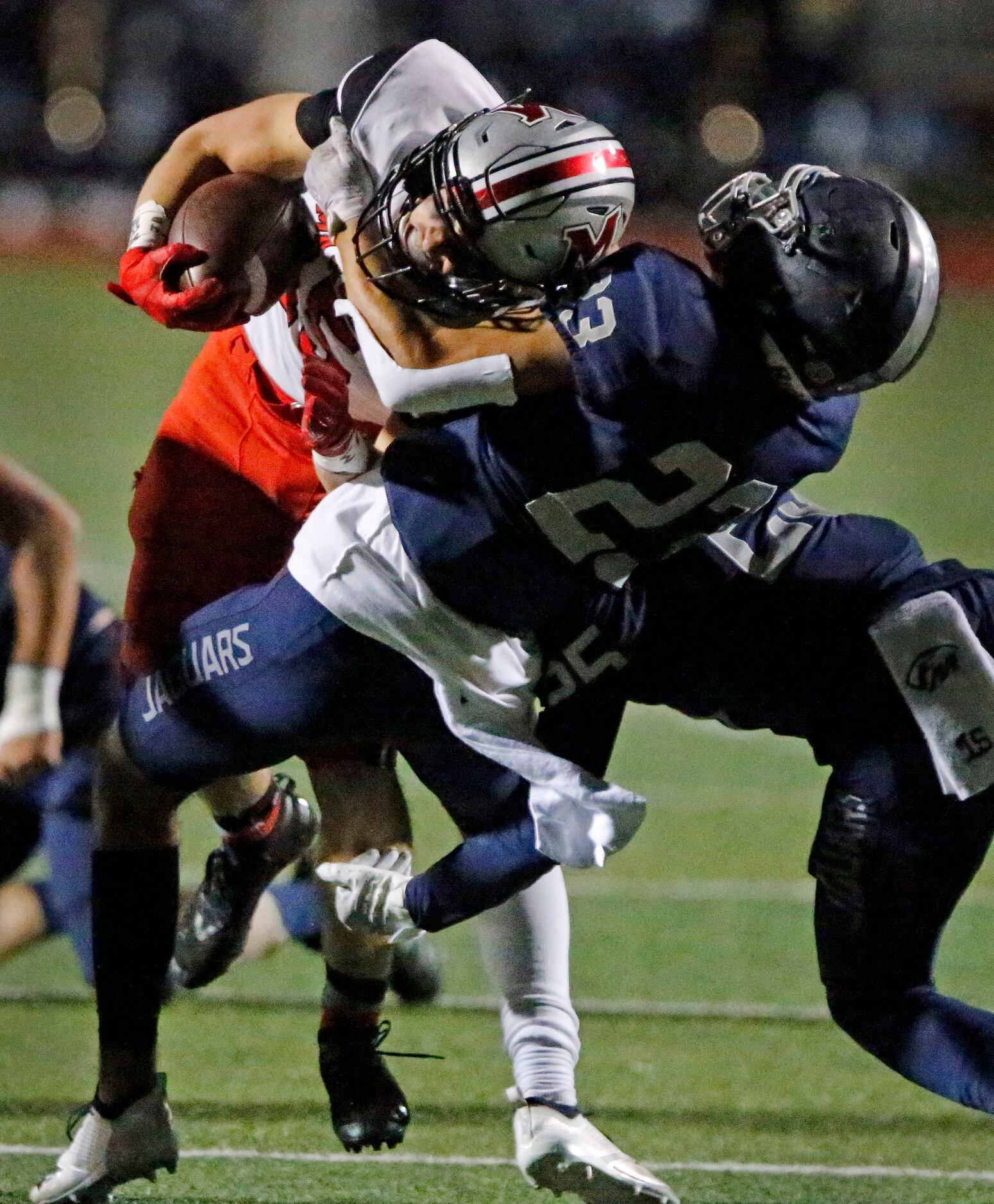 Flower Mound Marcus running back Gabe Espinoza (15) is tackled by Flower Mound High School...