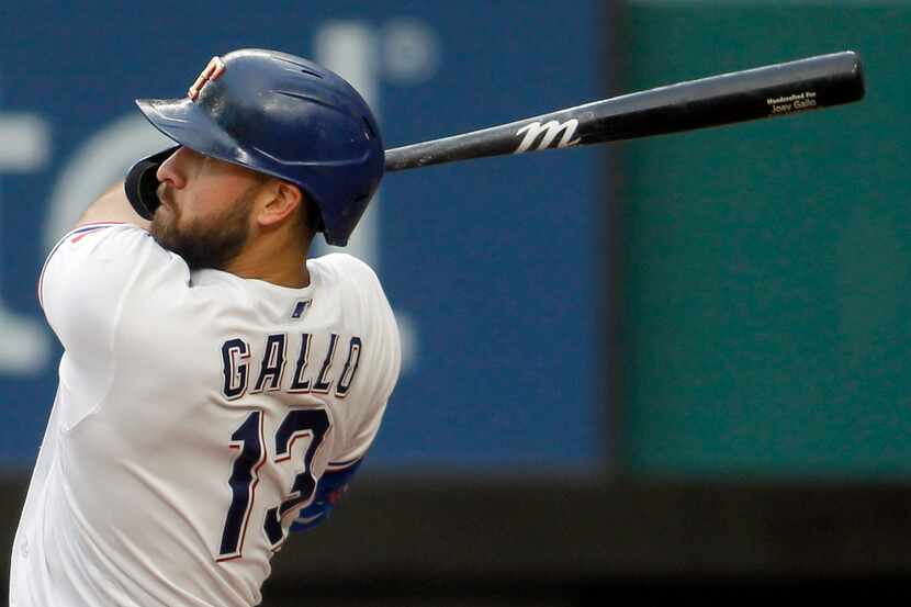 Texas Rangers outfielder Joey Gallo (13) powers through a pitch which he drove for a...