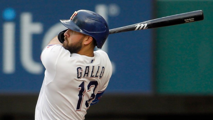 Texas Rangers outfielder Joey Gallo (13) powers through a pitch which he drove for a...