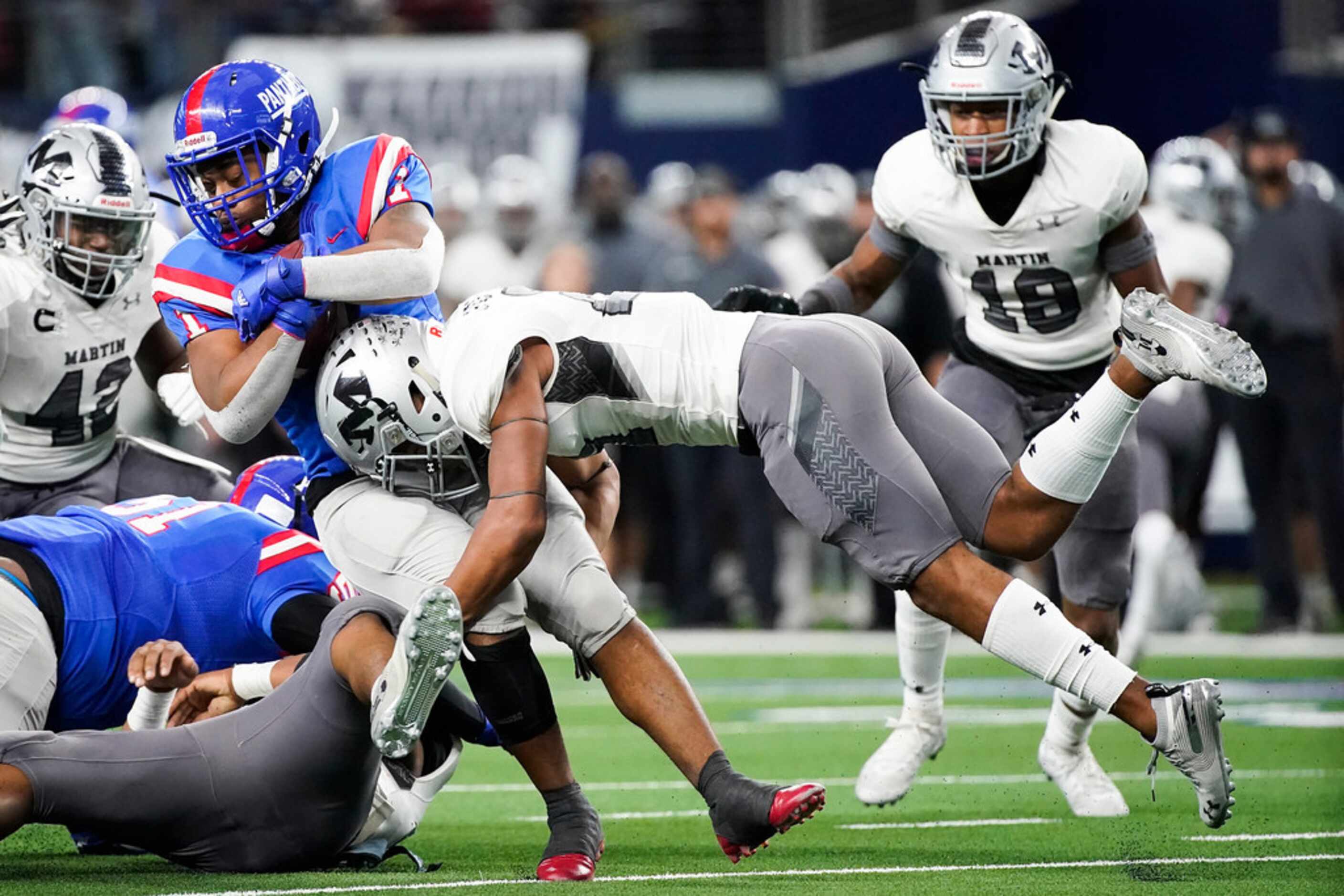 Duncanville running back Trysten Smith (1) is brought down by Arlington Martin linebacker...