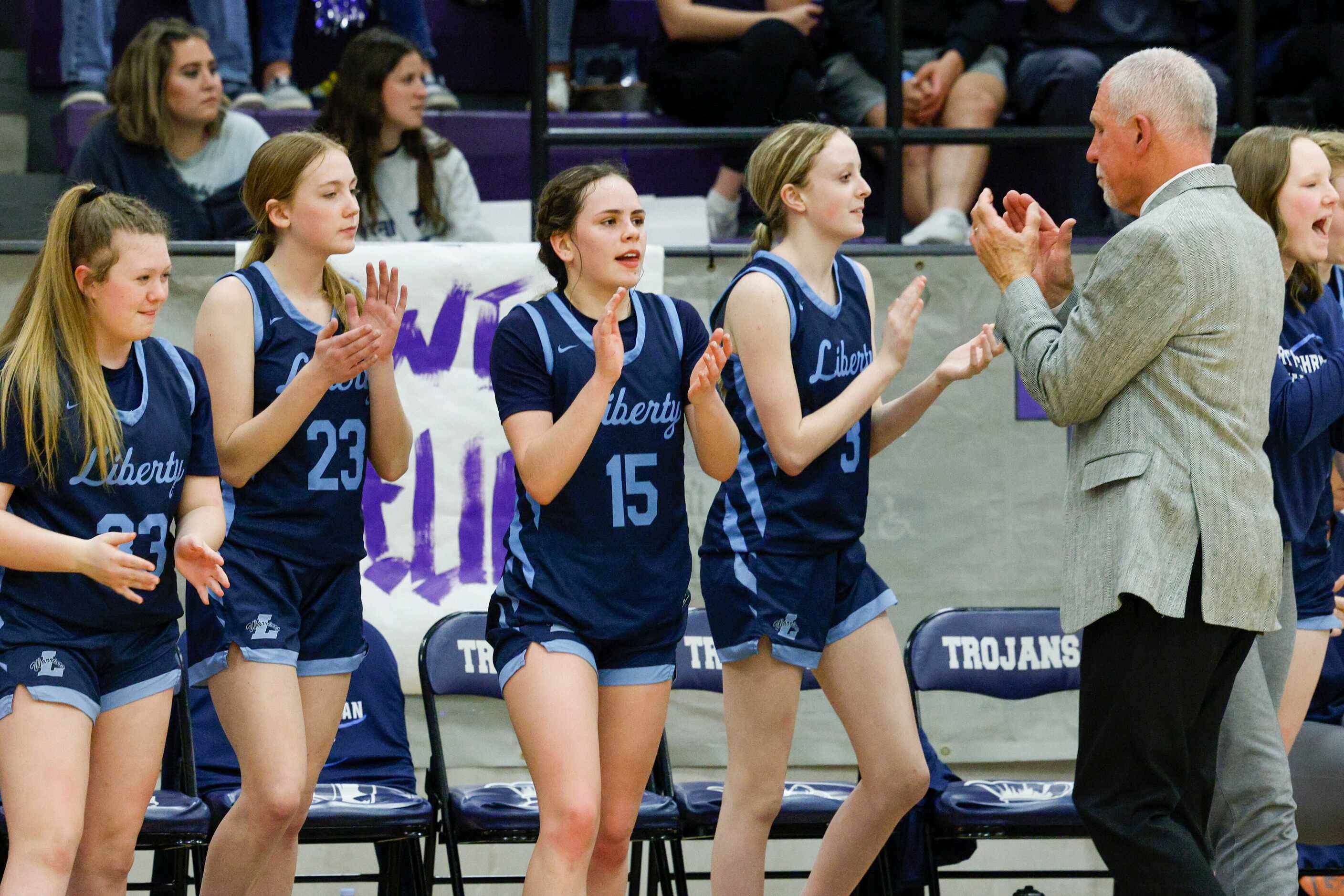 Argyle Liberty Christian head coach Ken Burroughs celebrates with his team after winning a...