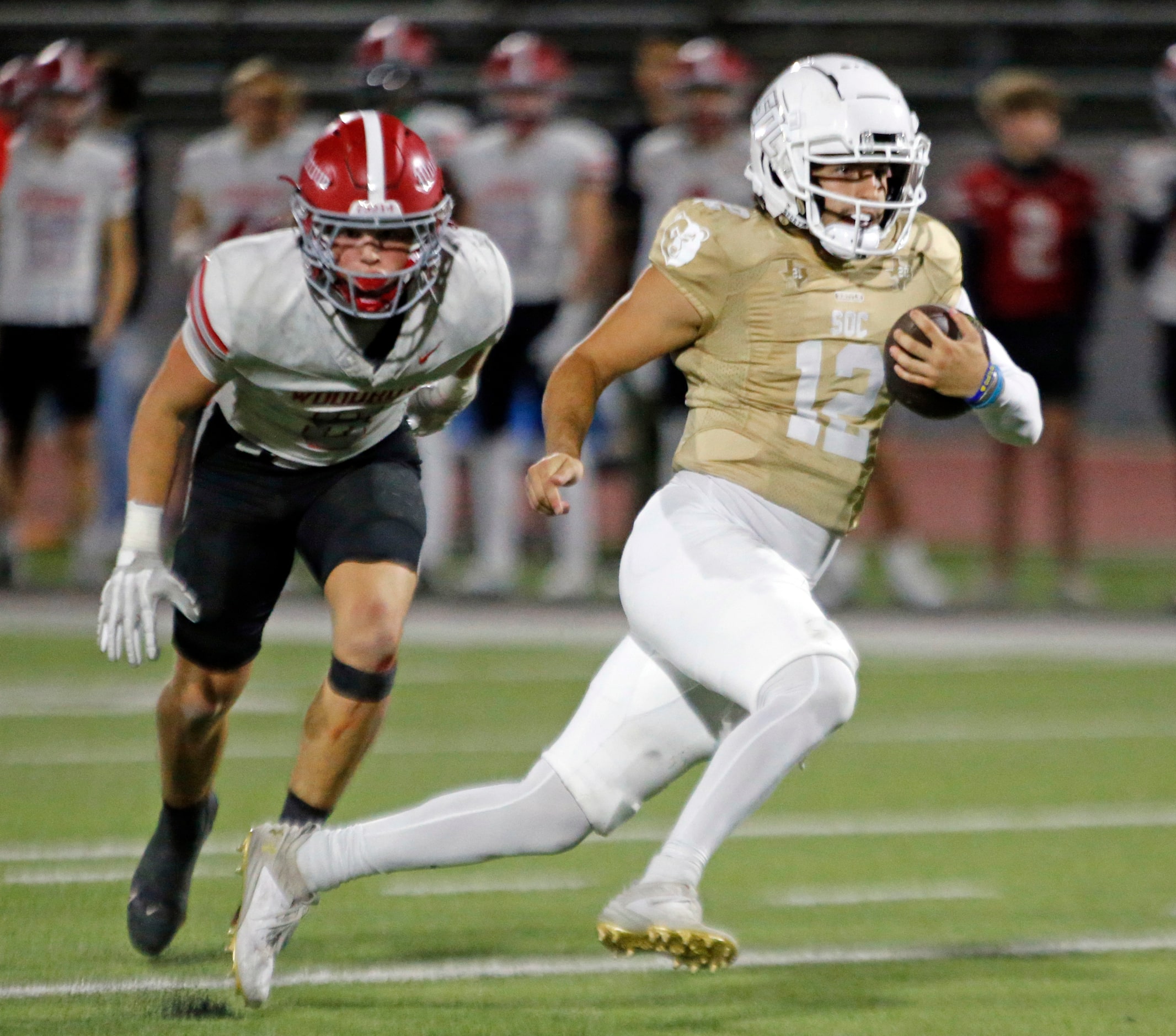 South Oak Cliff High QB Carter Kopecky (12) scrambles for yardage during the first half of a...