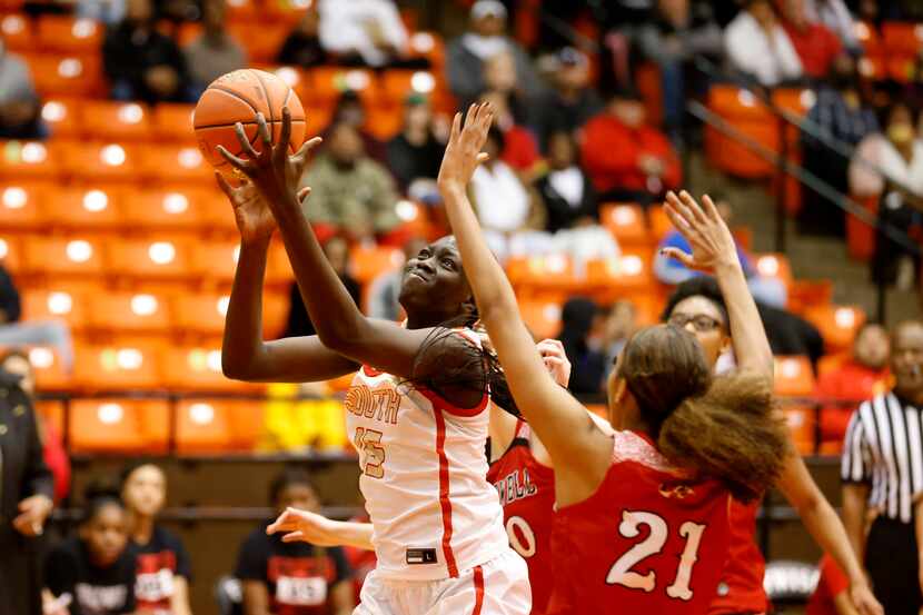South Grand Prairie’s Adhel Tac (15) shoots the ball in front of Denton Braswell’s Yves Cox...