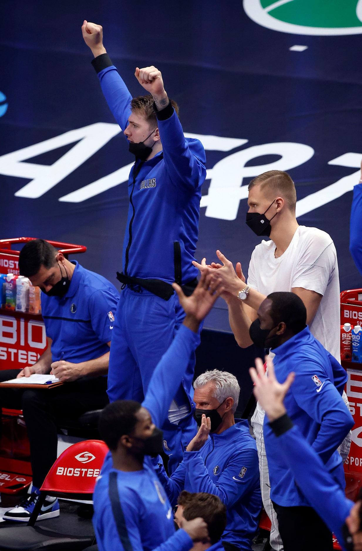 Dallas Mavericks guard Luka Doncic and his teammates celebrate a three-pointer near the ned...