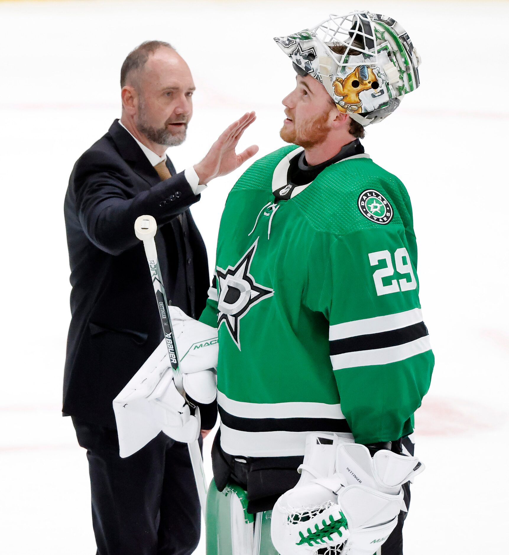 Dallas Stars head coach Peter DeBoer congratulates his goaltender Jake Oettinger (29)...