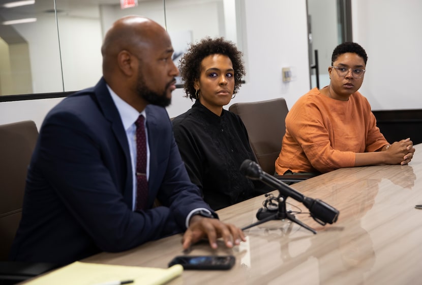 Chanise Condren (center) and her wife, Ashley Garner, listen to their attorney, Anthony...