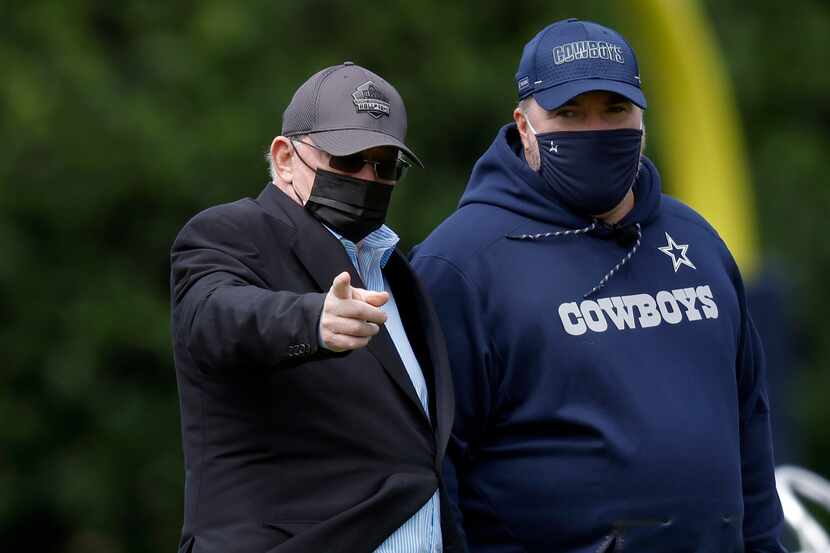 Dallas Cowboys owner Jerry Jones (left) and head coach Mike McCarthy visit on the sideline...