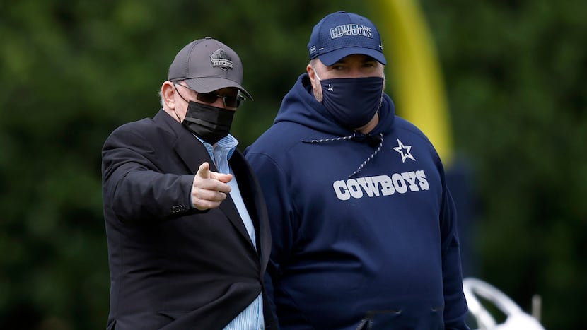 Dallas Cowboys owner Jerry Jones (left) and head coach Mike McCarthy visit on the sideline...