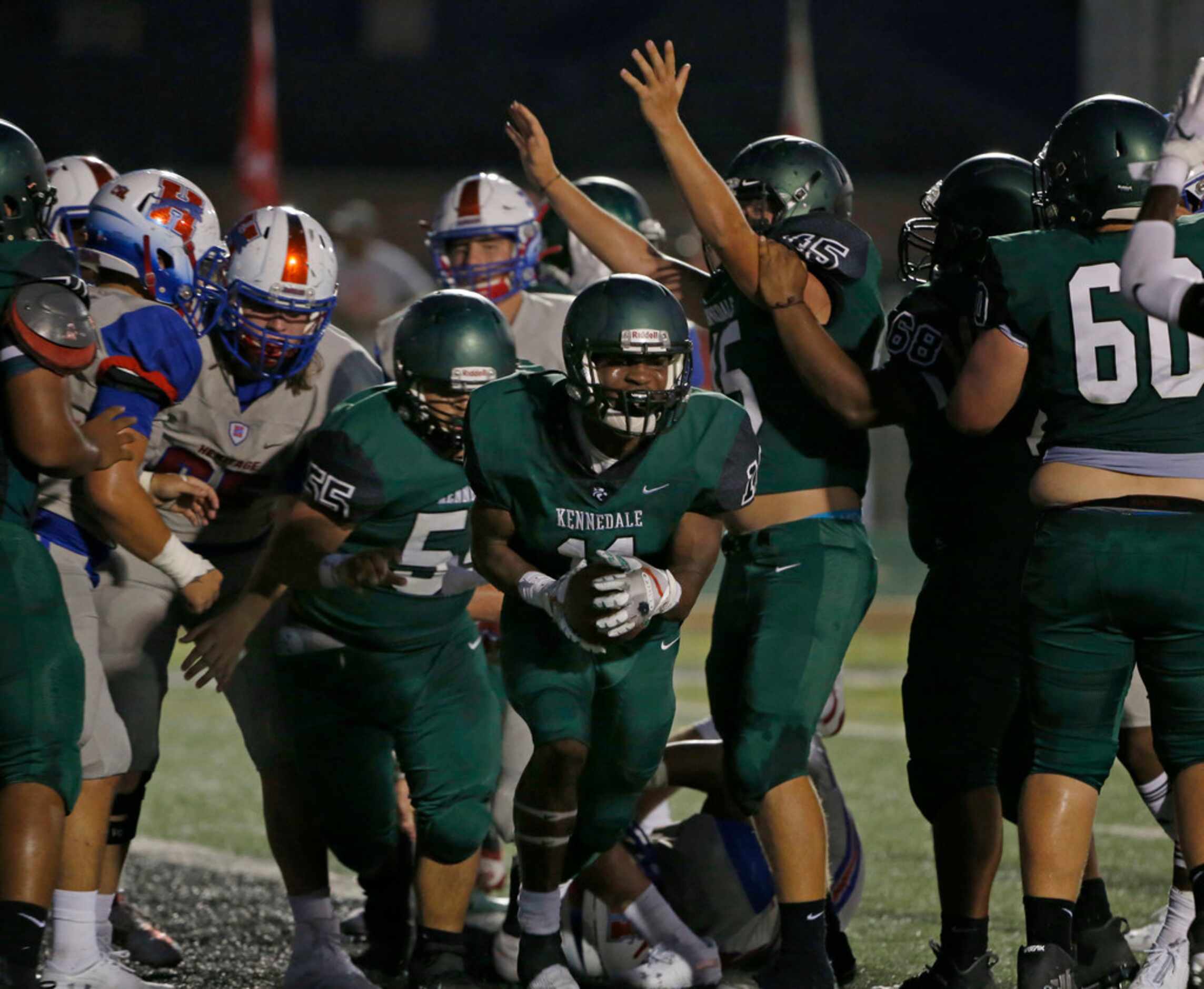 Kennedale's Keirahyin Brown (11) celebrates  his touchdown against Midlothian Heritage...