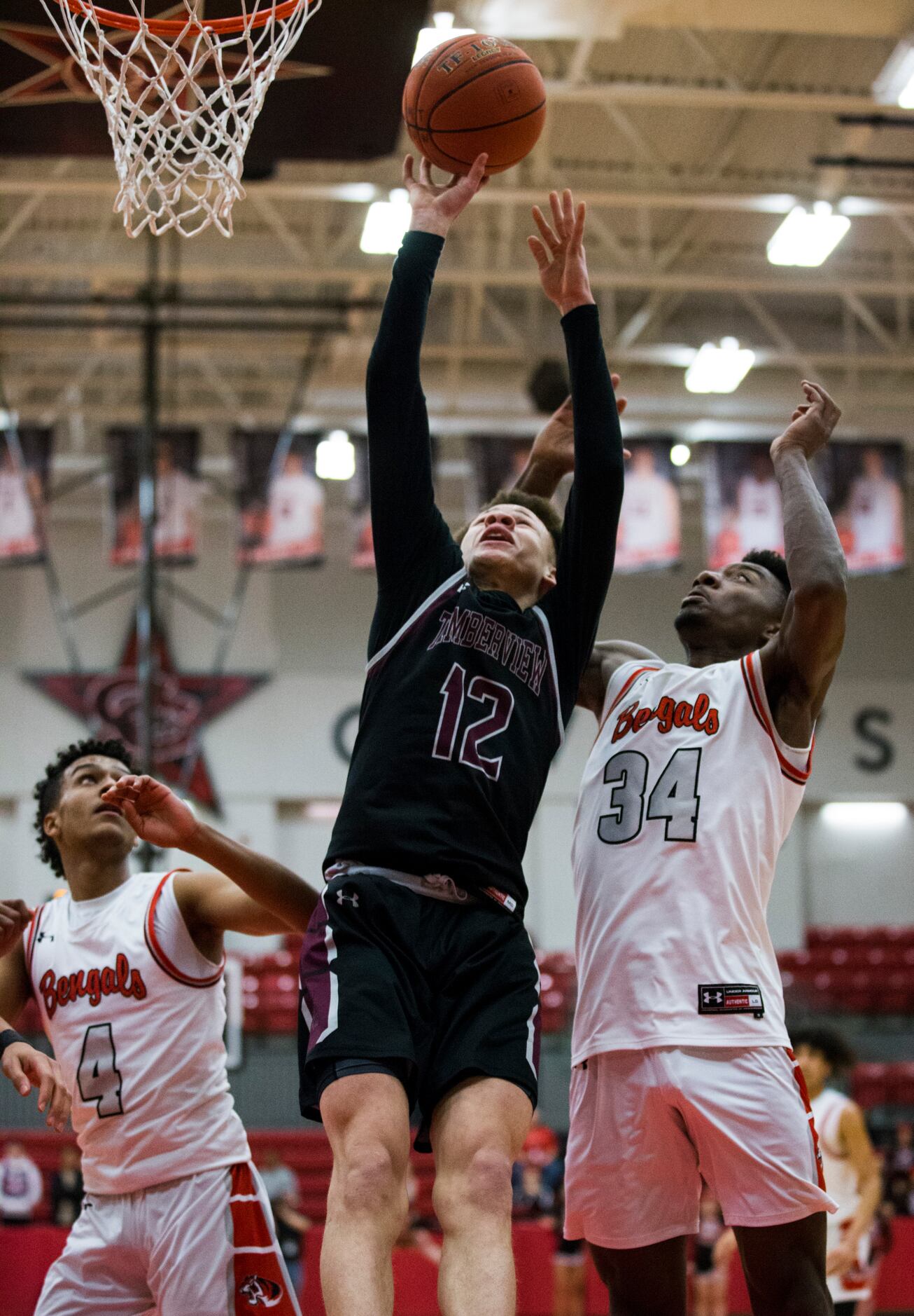 Mansfield Timberview guard Chendall Weaver (12) goes up for a shot between Denton Braswell...