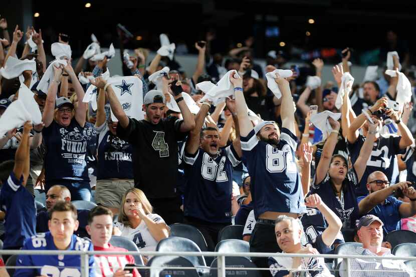 Dallas Cowboys fans participate in the wave during the second half of play at AT&T Stadium...