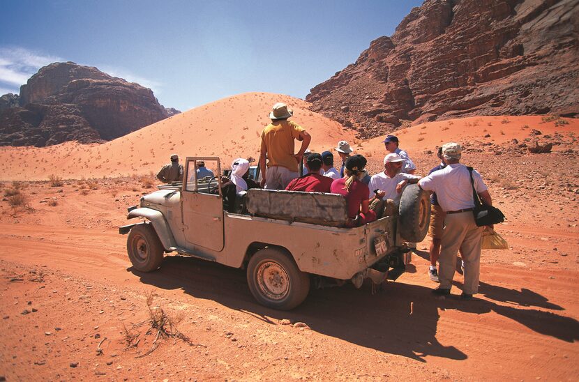 Tourists visit the otherworldly sites of Wadi Rum.