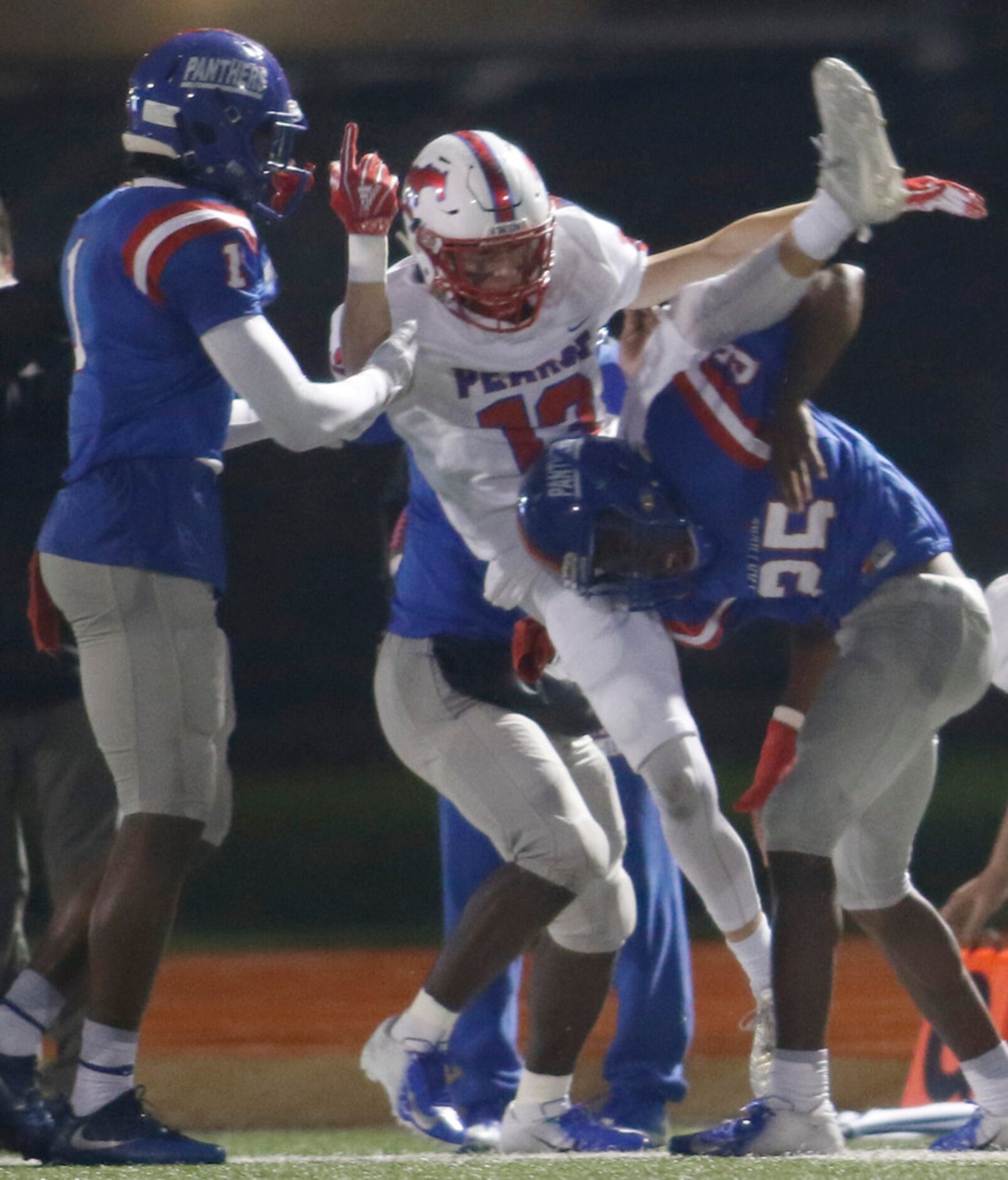 Duncanville defensive back Thailand Scott (25) seemed to somehow become engaged in an aerial...